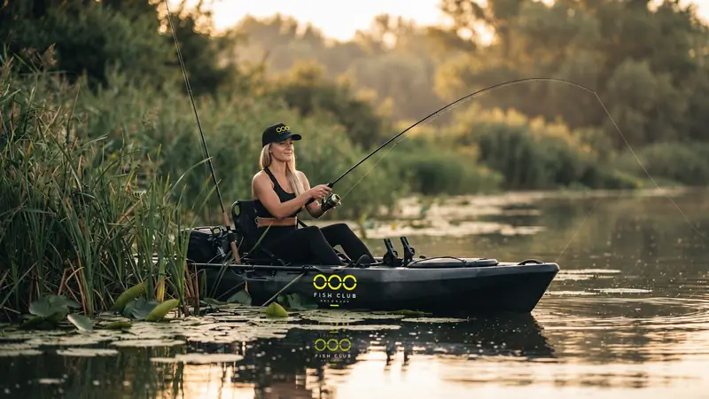 Member fishing from an OOO kayak in the reeds